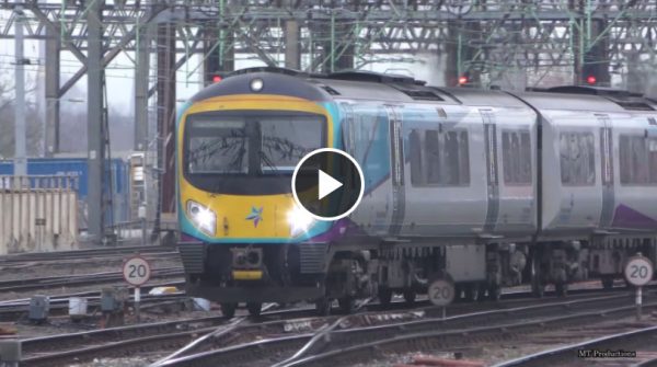 A passenger train moving through a large junction