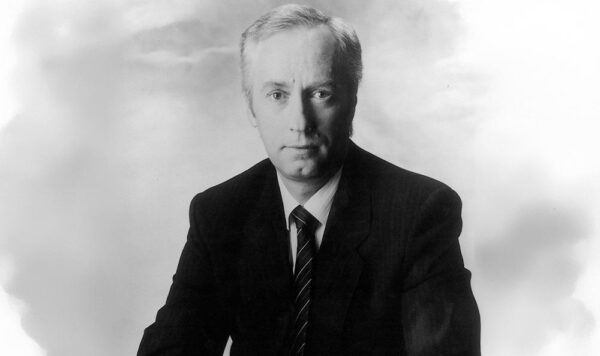 Jon Neill headshot in black and white from 1980s.