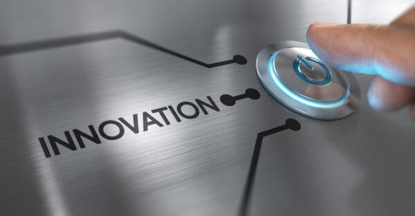 Finger about to press a start button with the word innovation on the left.
