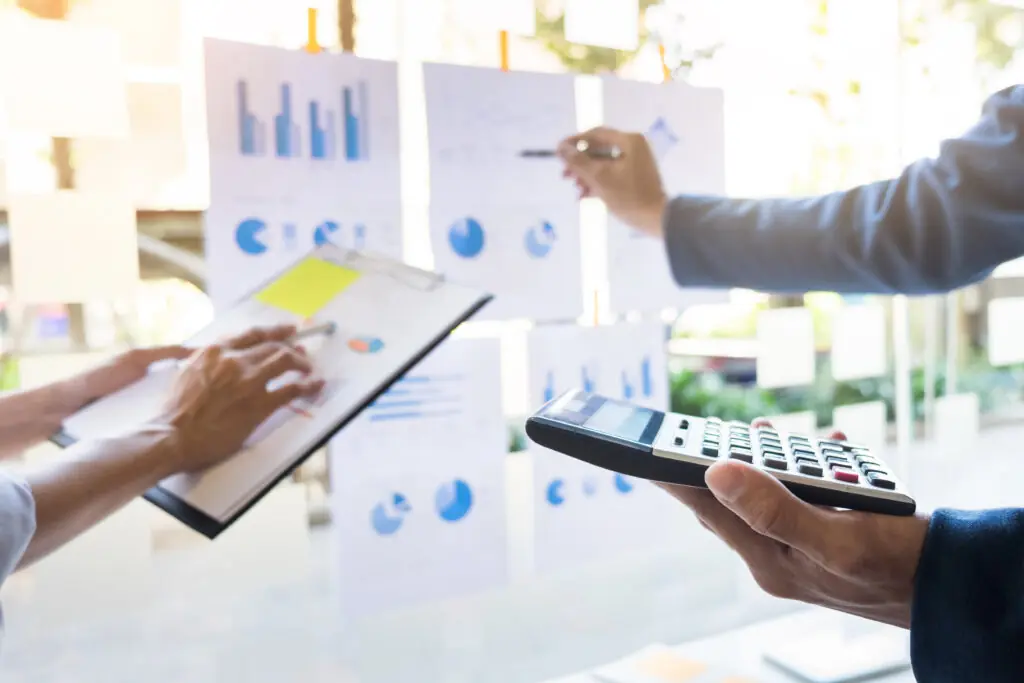 business man financial inspector and secretary making report, calculating or checking balance. Internal Revenue Service inspector checking document.