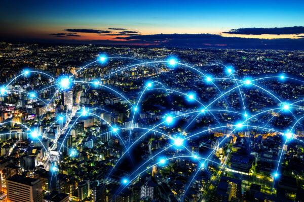 A city at dusk with sparks and connections between different buildings. Smart city and telecommunication network concept.