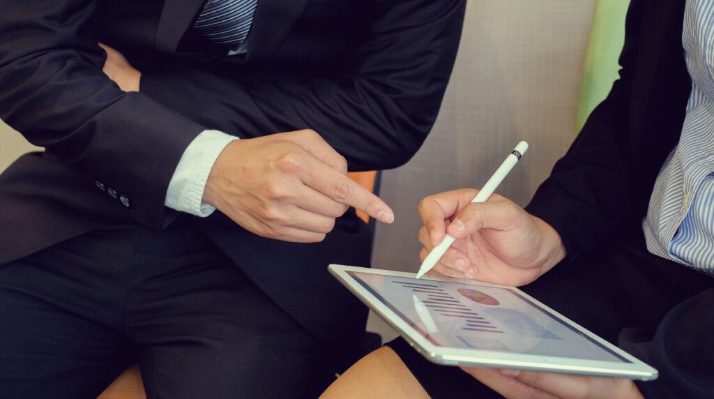 investor businesswoman hand point on tablet pad display for consult stock statistic
