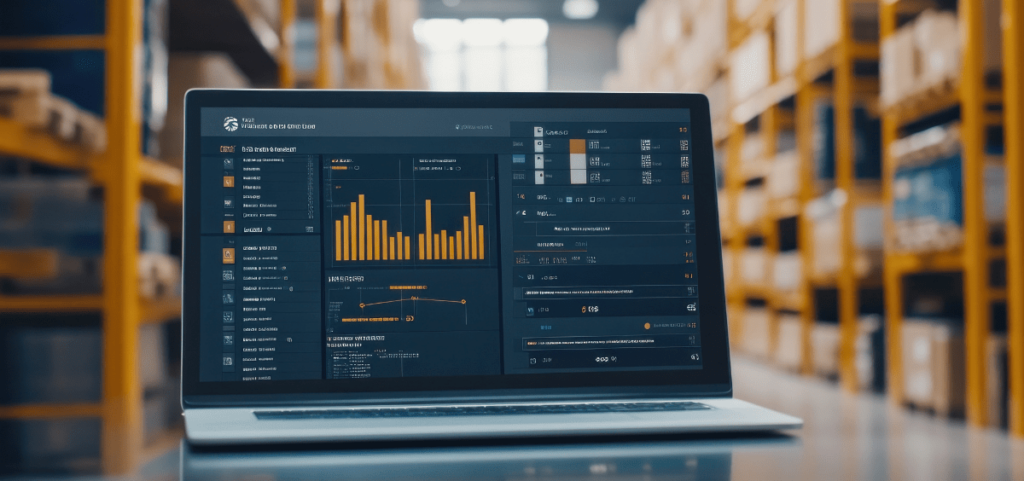 Laptop with charts and tracking on table in a warehouse.