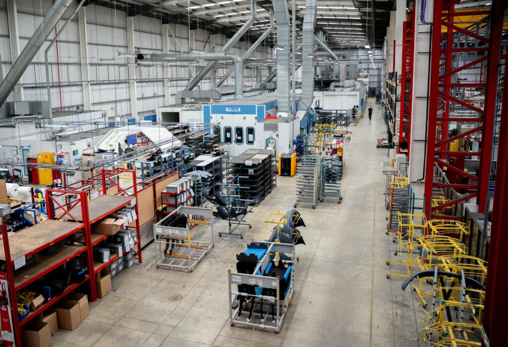 Unipart Polymers and Composites site showing red racking and machinery.
