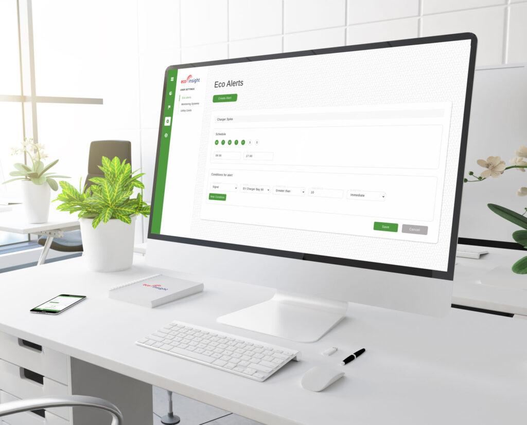 Modern desk with computer screen showing Eco Insight energy monitoring live alert screen.