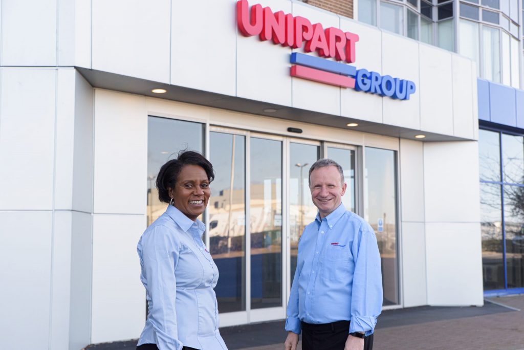 Two people outside the Unipart House main entrance