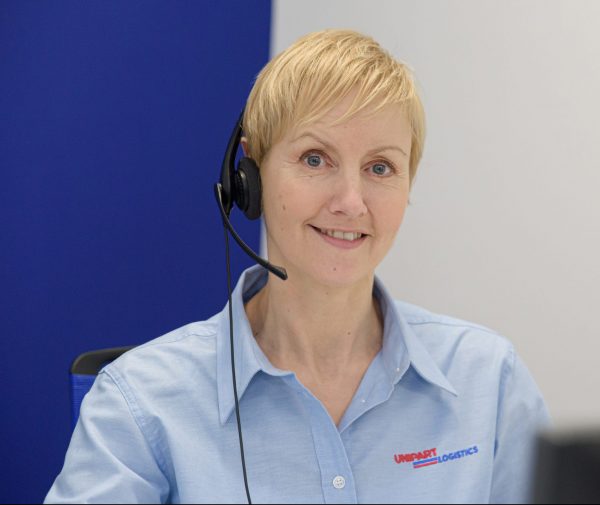 Image shows Unipart customer service team member on a call
